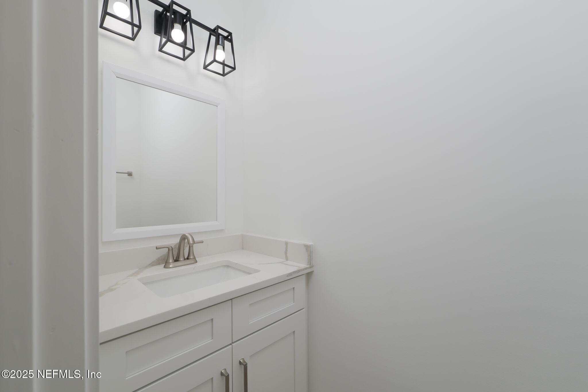 603-609 Twenty Second Street St. Augustine, FL 32084 - Photo 20 of 36 a bathroom with a sink and vanity