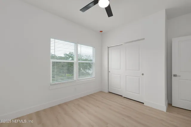 a bathroom with a toilet sink a mirror and shower