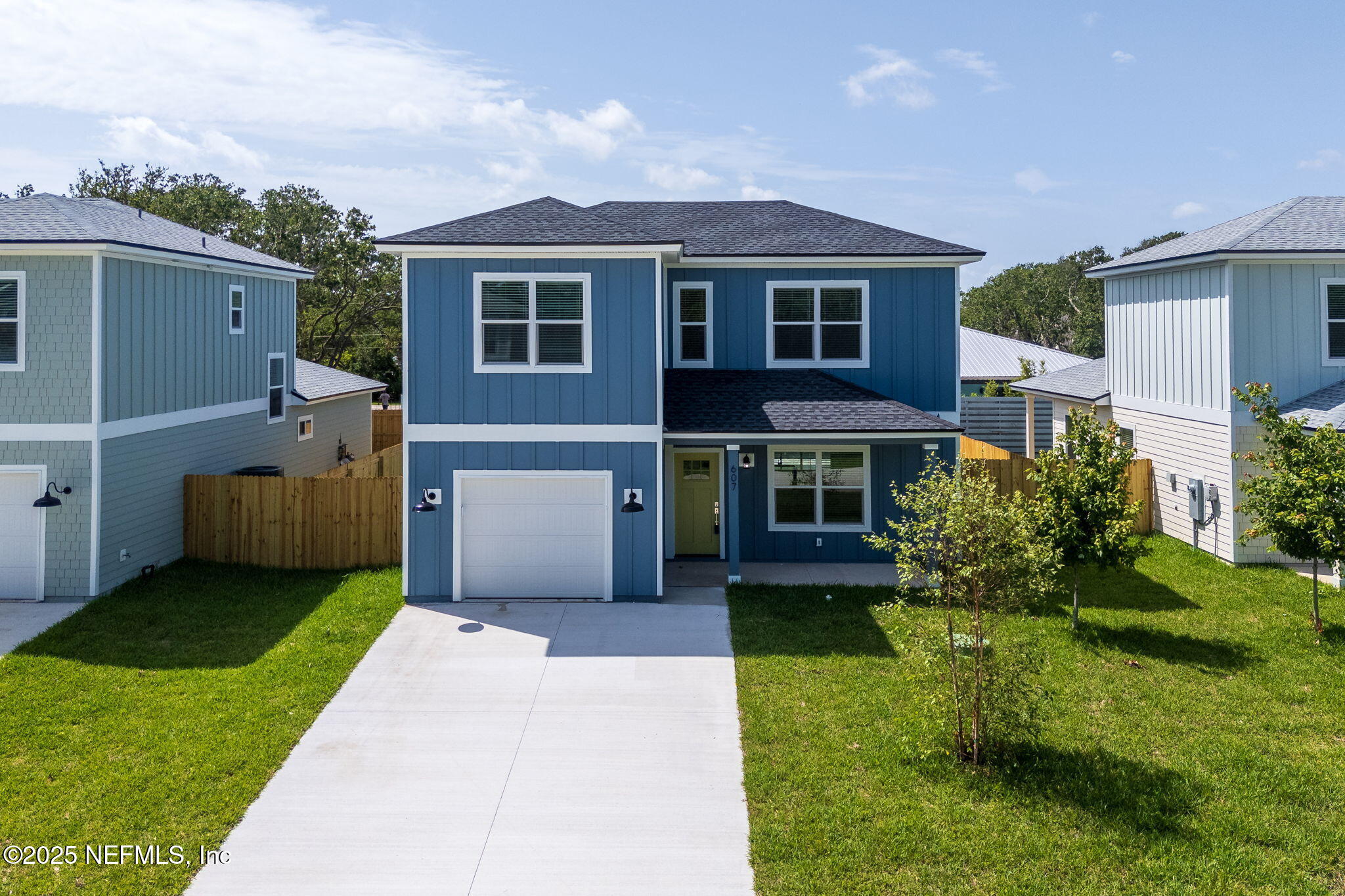 603-609 Twenty Second Street St. Augustine, FL 32084 - Photo 7 of 36 a front view of a house with a yard and garage