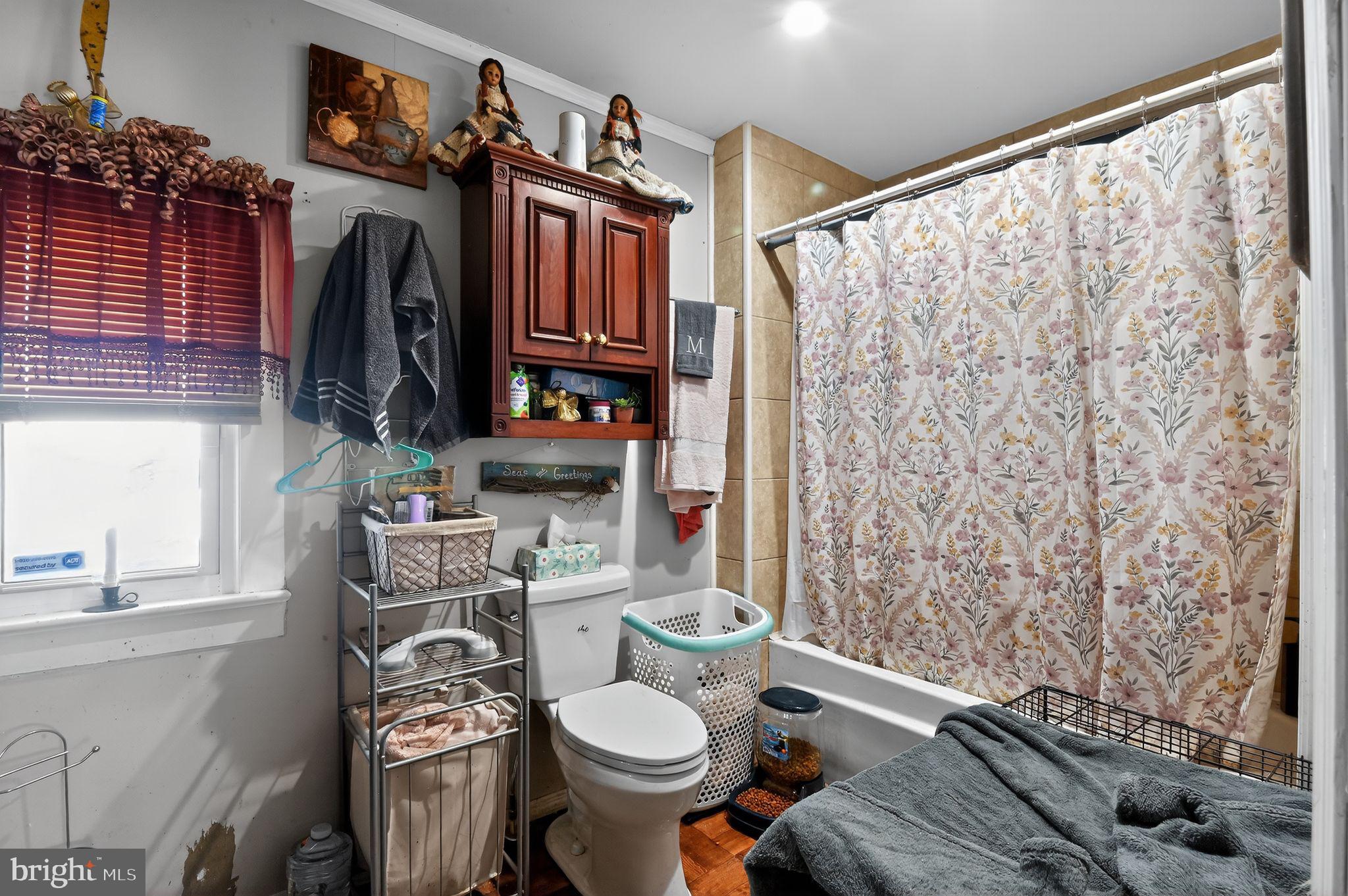 318 Newport Neck Road Newport, NJ 08345 - Photo 20 of 25 a bathroom with a toilet sink and shower curtain