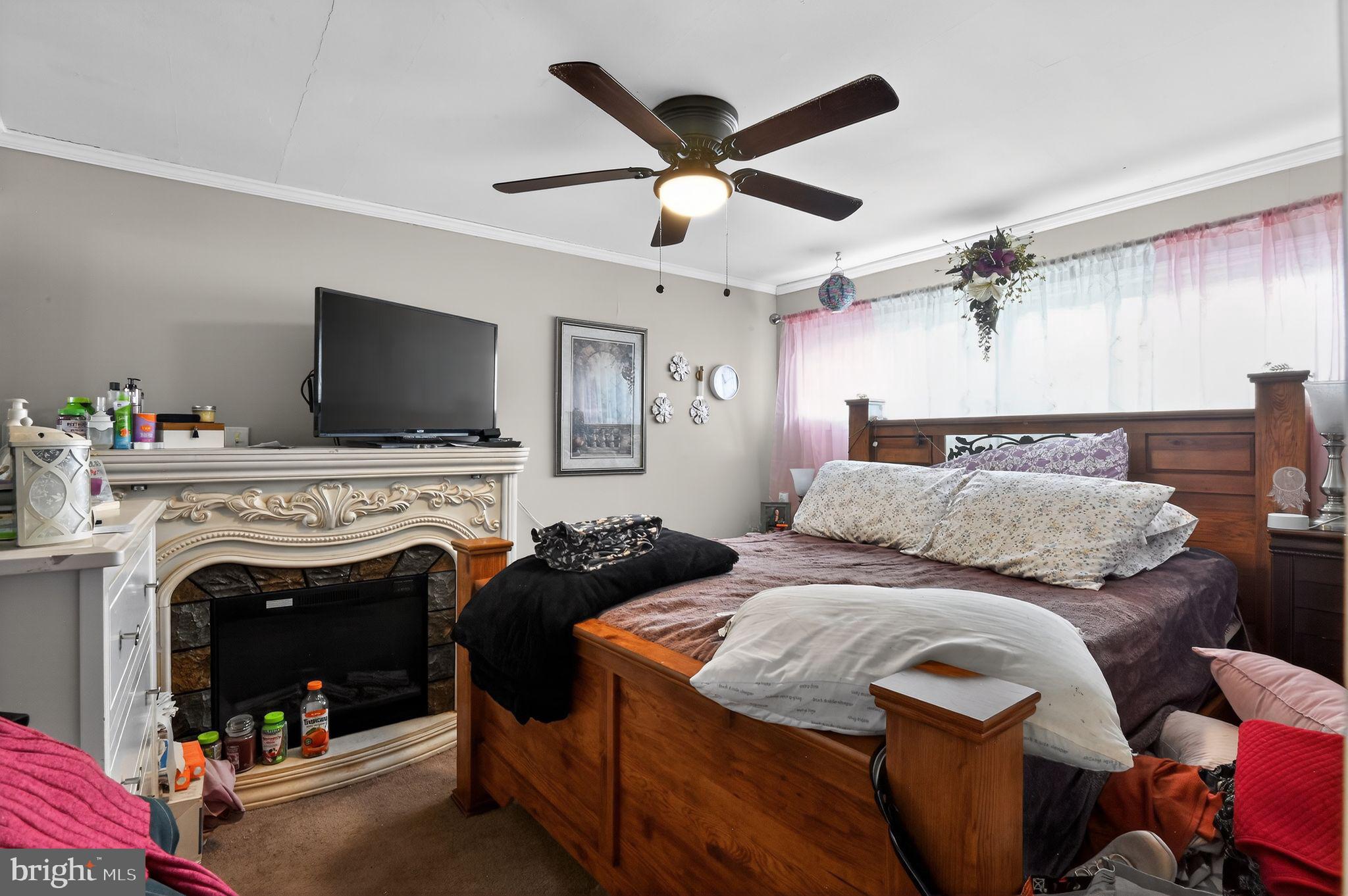 318 Newport Neck Road Newport, NJ 08345 - Photo 22 of 25 a bedroom with a bed and a fireplace