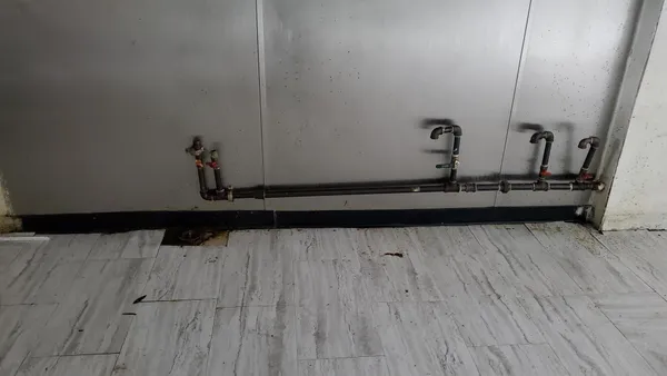 a view of water heater room with wooden floor