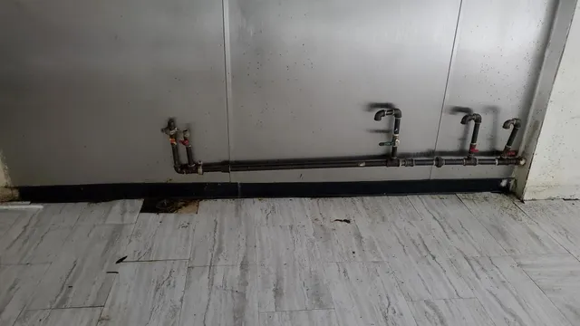 a view of water heater room with wooden floor