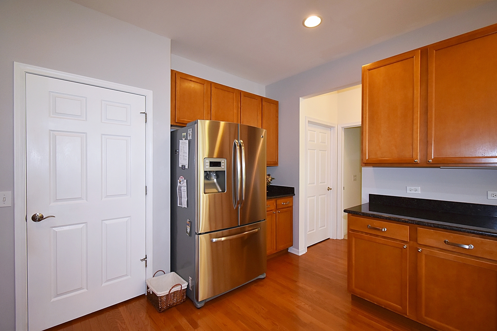 160 Orchards Pass Bartlett, IL 60103 - Photo 16 of 46 a kitchen with wooden floors and stainless steel appliances