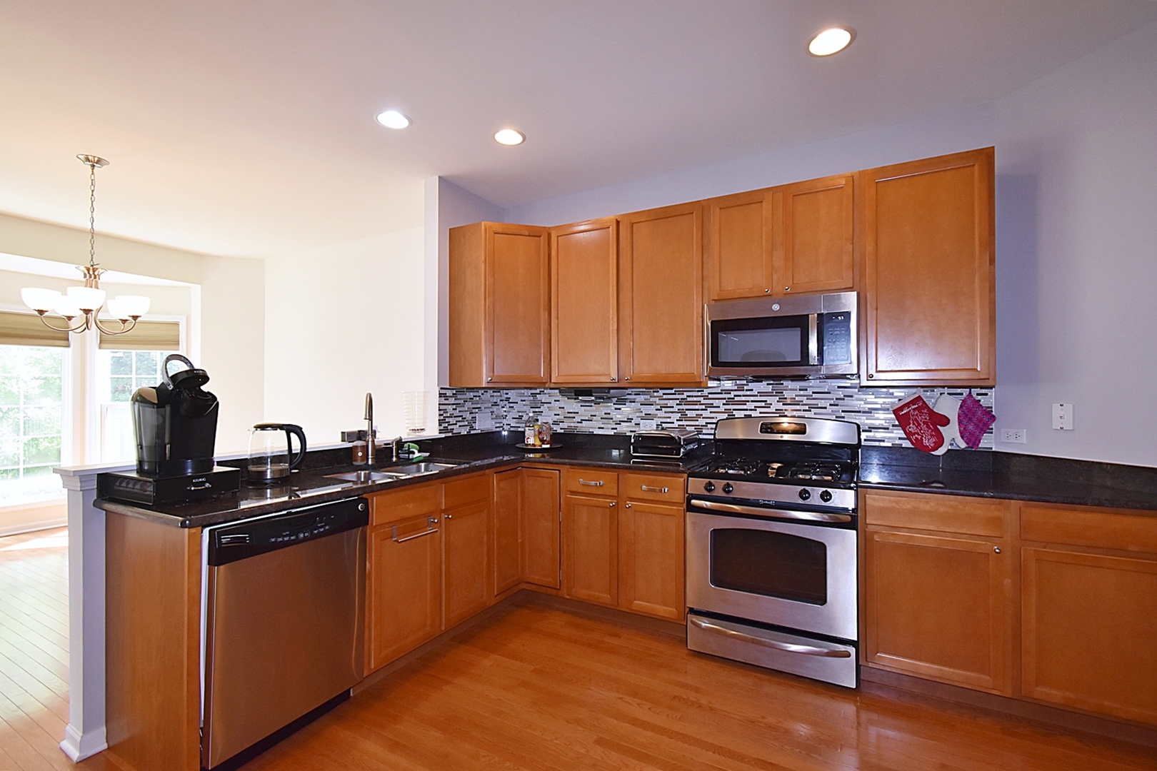 160 Orchards Pass Bartlett, IL 60103 - Photo 17 of 46 a kitchen with granite countertop a sink cabinets and stainless steel appliances