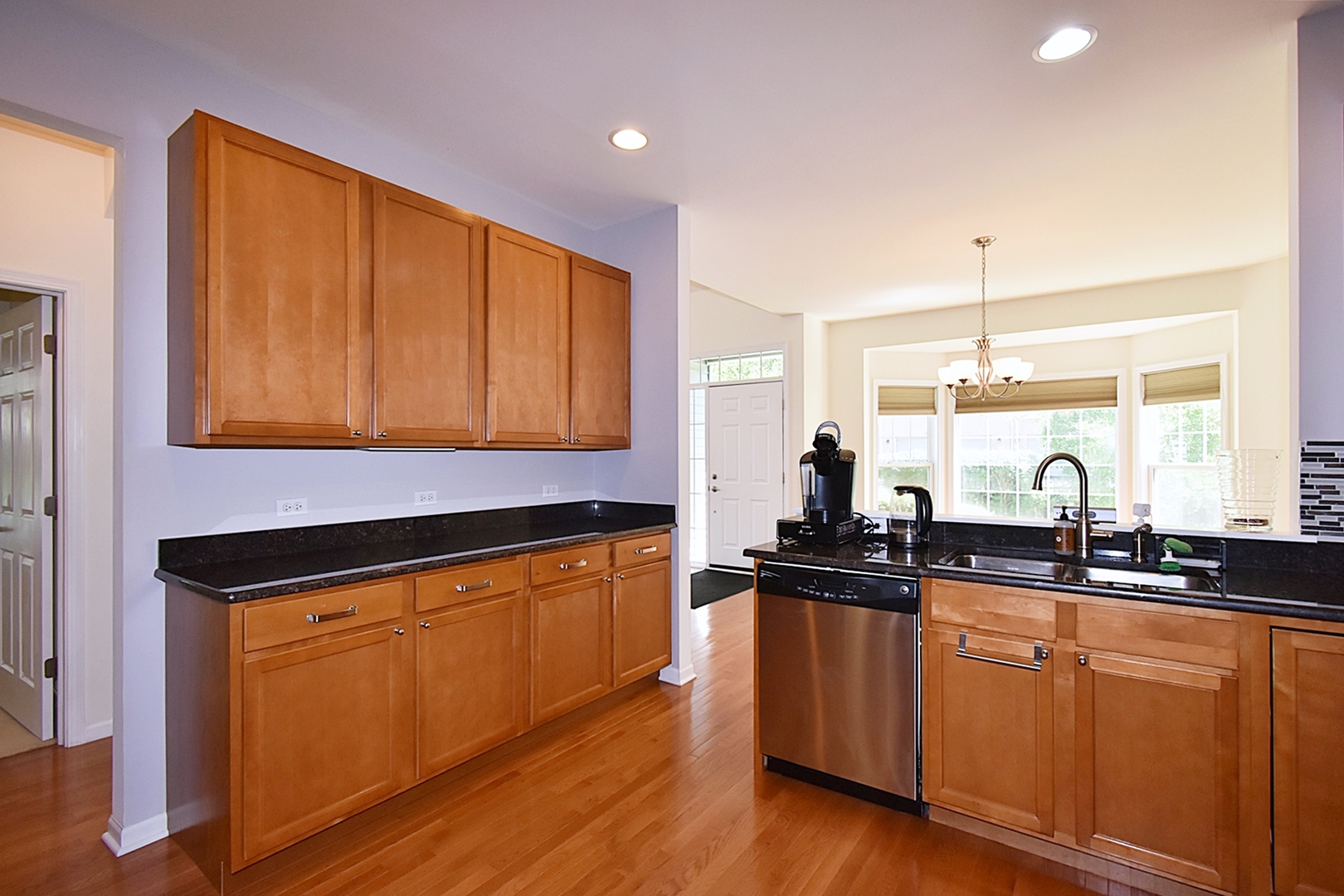 160 Orchards Pass Bartlett, IL 60103 - Photo 18 of 46 a kitchen with granite countertop a sink a counter space appliances and cabinets
