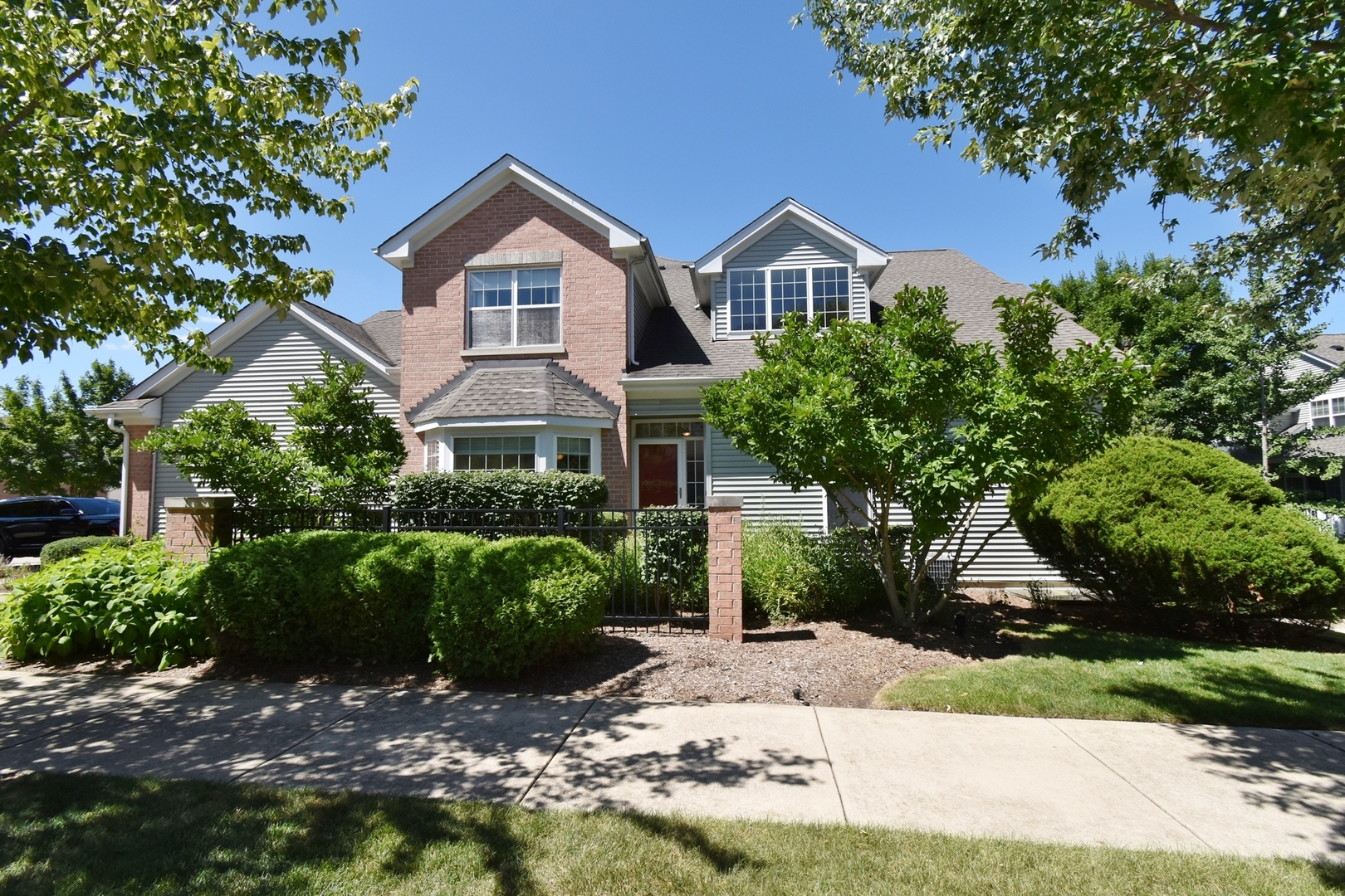 160 Orchards Pass Bartlett, IL 60103 - Photo 5 of 46 a front view of a house with a yard and garage