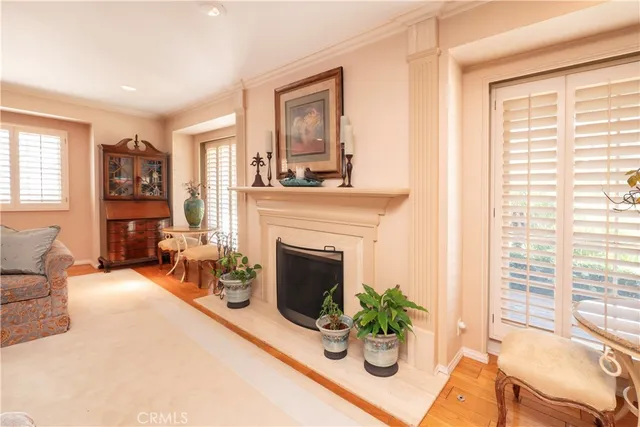 a dining hall with stainless steel appliances granite countertop a kitchen island a stove and a refrigerator with wooden floor