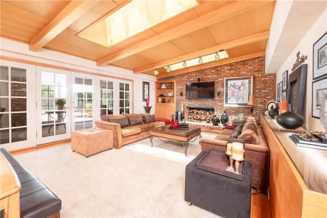 a spacious bedroom with a bed and wooden floor