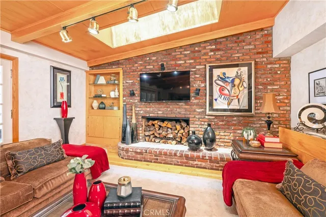 a living room with furniture a large window and a chandelier