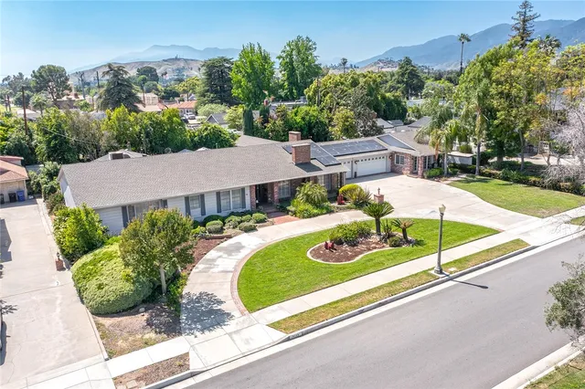 an aerial view of a house with a yard and potted plants