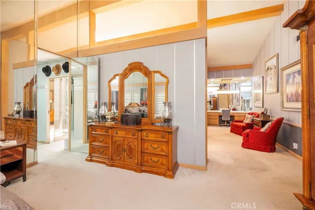 a living room with furniture a flat screen tv and floor to ceiling window