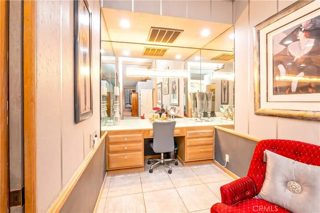 a spacious bathroom with a granite countertop sink a toilet and a mirror