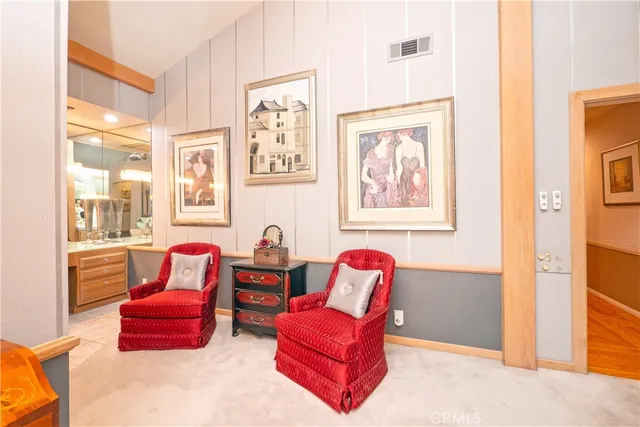 a view of a patio with chairs and floor to ceiling window and backyard