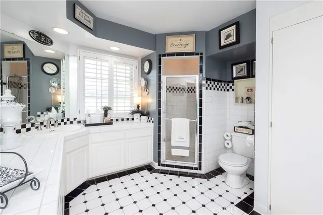 a living room with furniture floor to ceiling window and garden