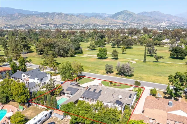 a living room with furniture a fireplace and a large window
