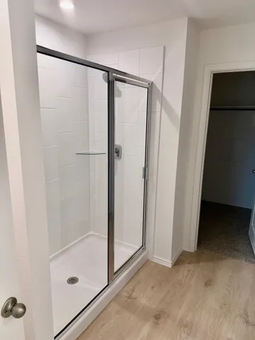 a bathroom with a glass shower door