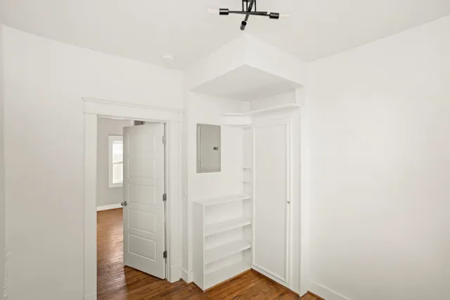 a view of a hallway with wooden floor