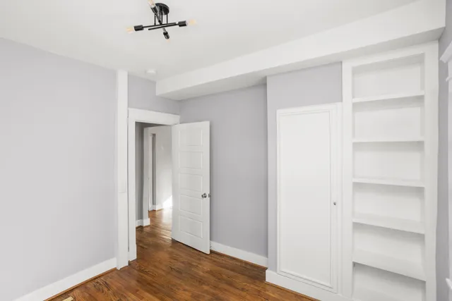 a view of a room with wooden floor