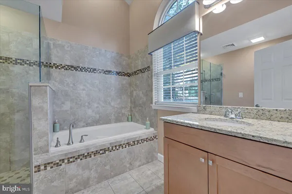 a bedroom with a large bed and a large mirror