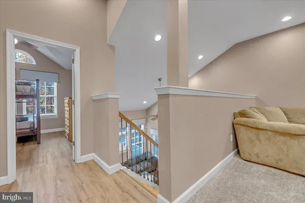 a living room with lots of furniture and kitchen view