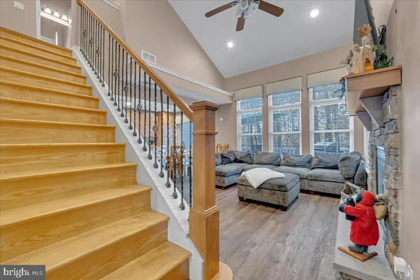 a living room with furniture or stairs and a wooden floor