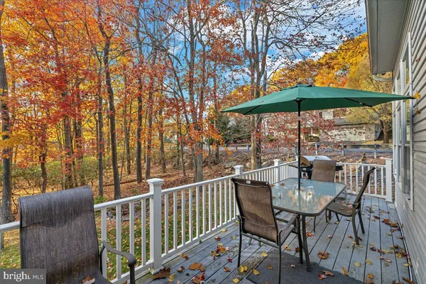 a balcony with table and chairs