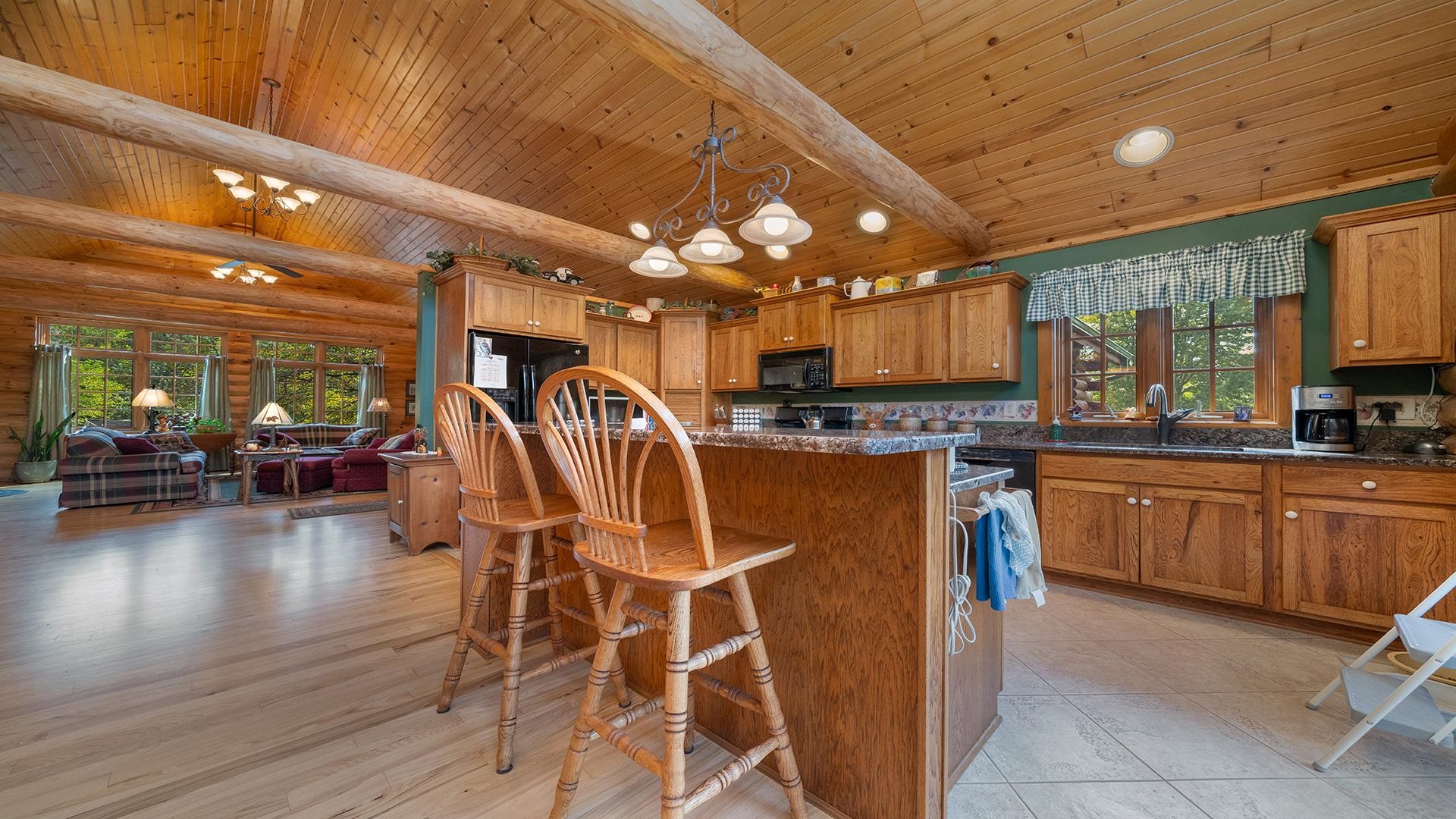 5810 West Lightsville Road Leaf River, IL 61047 - Photo 18 of 68 a kitchen with stainless steel appliances kitchen island granite countertop a table chairs in it and wooden floors
