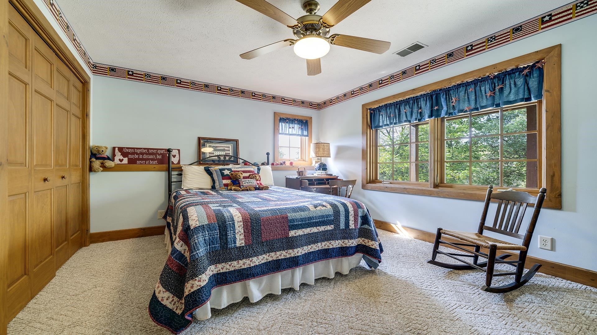 5810 West Lightsville Road Leaf River, IL 61047 - Photo 31 of 68 a bedroom with a bed and a chandelier