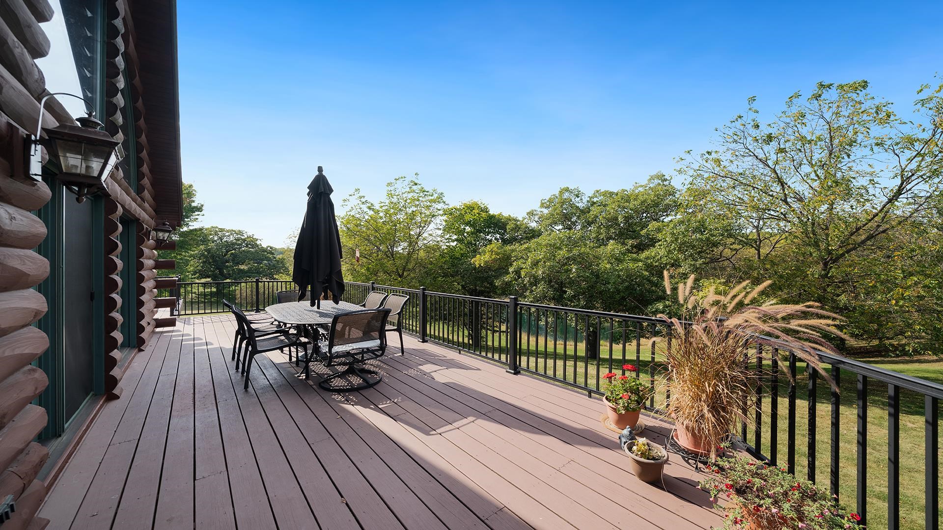 5810 West Lightsville Road Leaf River, IL 61047 - Photo 38 of 68 a view of balcony with chairs and wooden fence