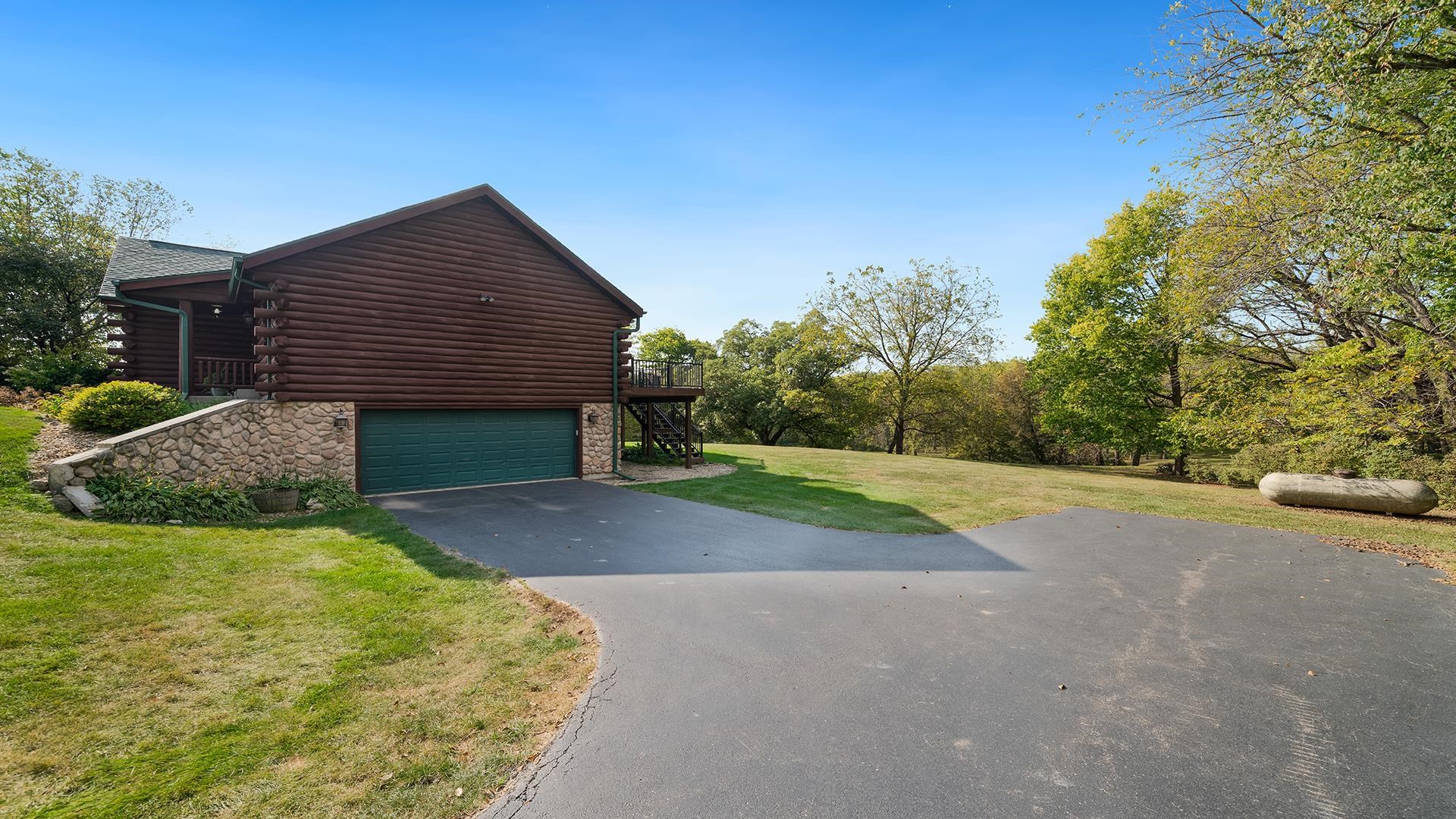 5810 West Lightsville Road Leaf River, IL 61047 - Photo 48 of 68 a view of a house with backyard and bushes