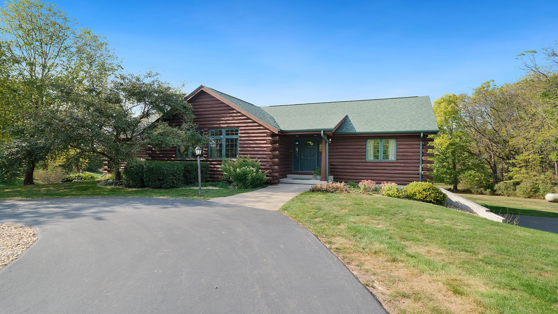 5810 West Lightsville Road Leaf River, IL 61047 - Photo 49 of 68 a front view of a house with a garden and yard