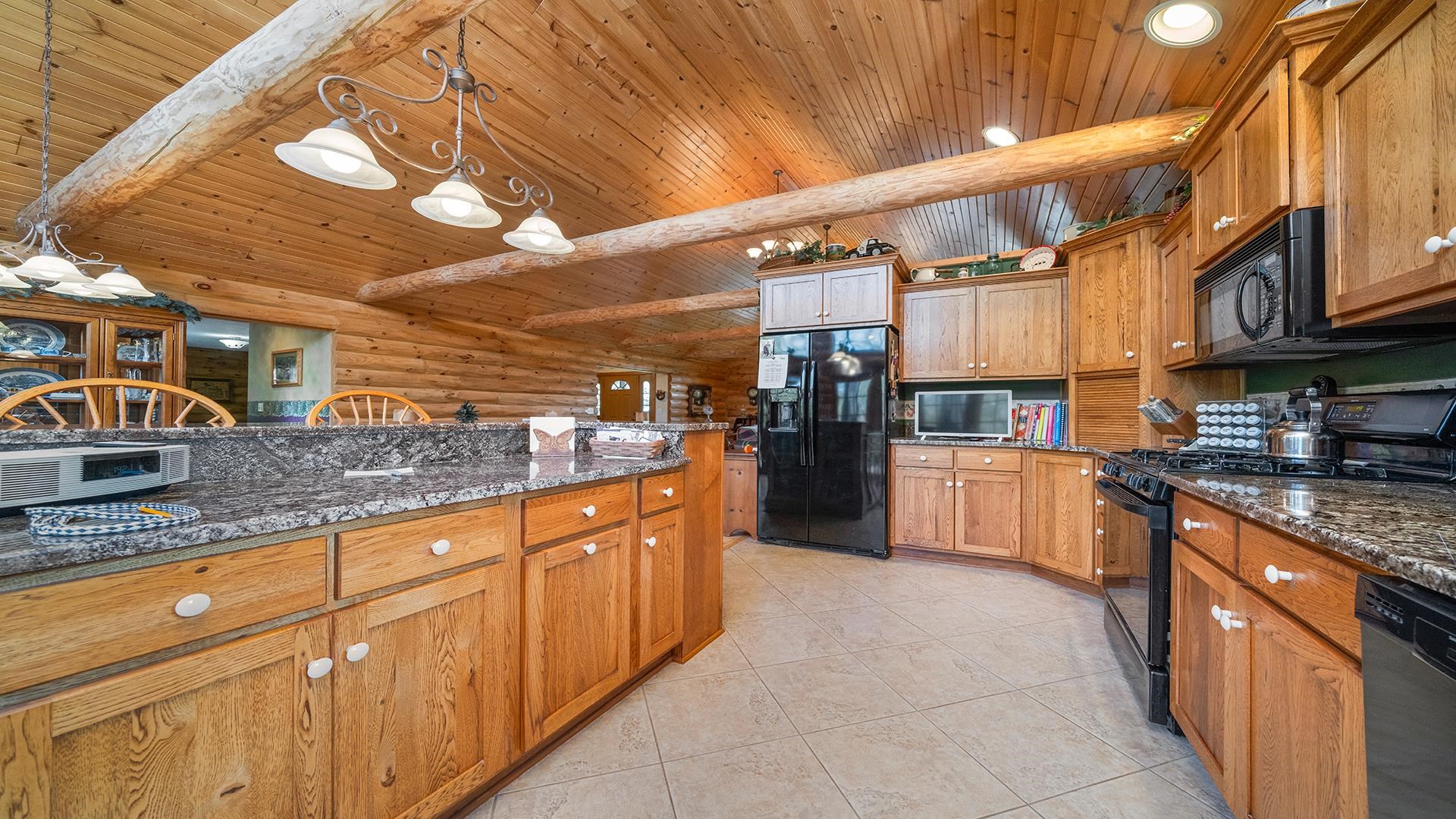 5810 West Lightsville Road Leaf River, IL 61047 - Photo 5 of 68 a large kitchen with stainless steel appliances granite countertop a sink and cabinets