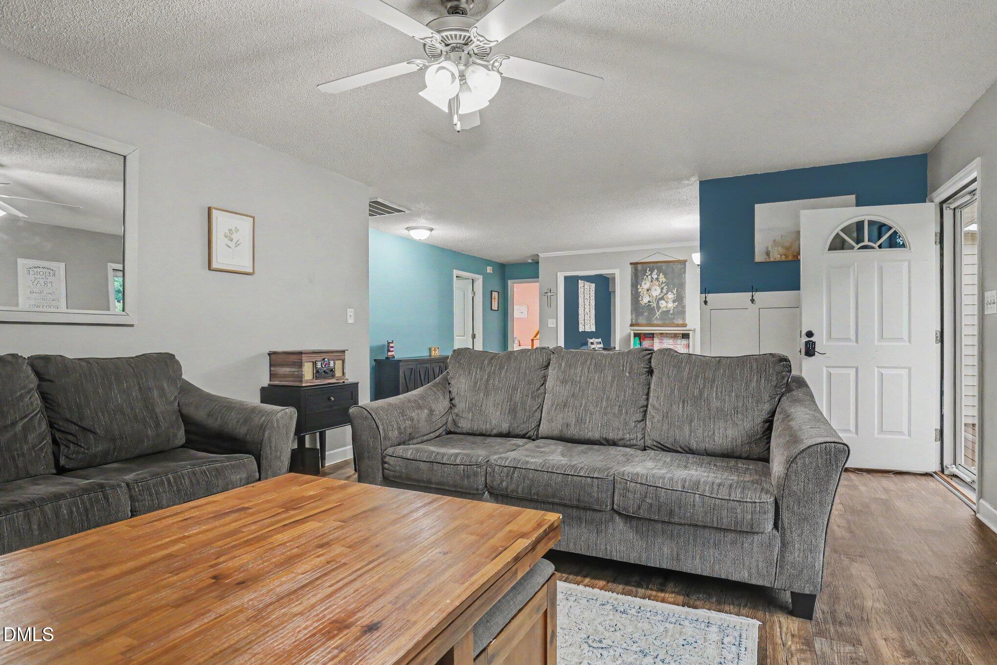 977 Stevens Mill Road Goldsboro, NC 27530 - Photo 7 of 31 a living room with furniture and a wooden floor