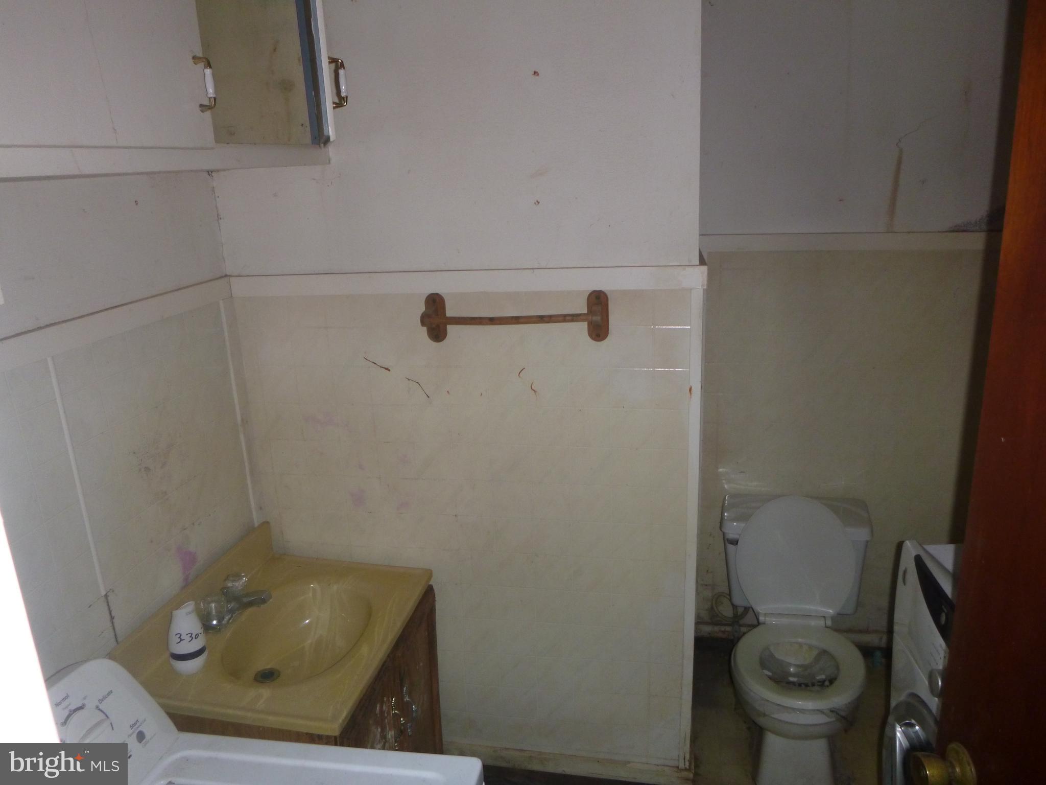 4159 Jacksonville Road Crisfield, MD 21817 - Photo 5 of 12 a bathroom with a toilet and a sink