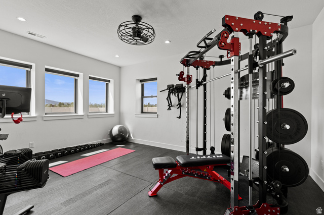 3111 South 1250 West Logan, UT 84321 - Photo 34 of 51 Dedicated fitness space featuring rubber flooring, recessed lighting, multiple large windows, and a ceiling fan