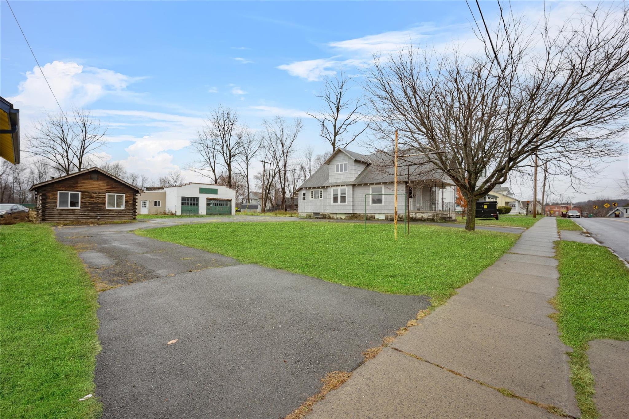 79 Maple Avenue Catskill, NY 12414 - Photo 2 of 35 View of front facade featuring a garage and a front lawn