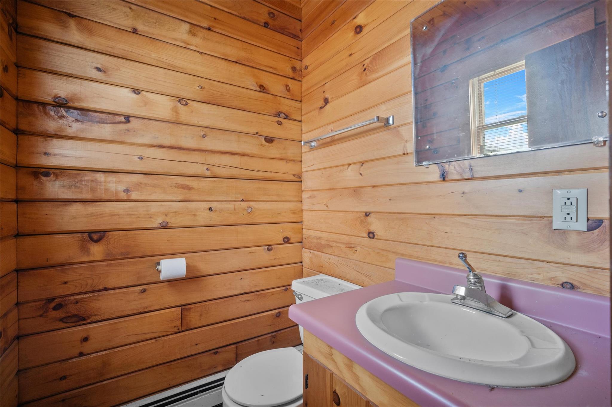 79 Maple Avenue Catskill, NY 12414 - Photo 21 of 35 Bathroom featuring toilet, wooden walls, and vanity