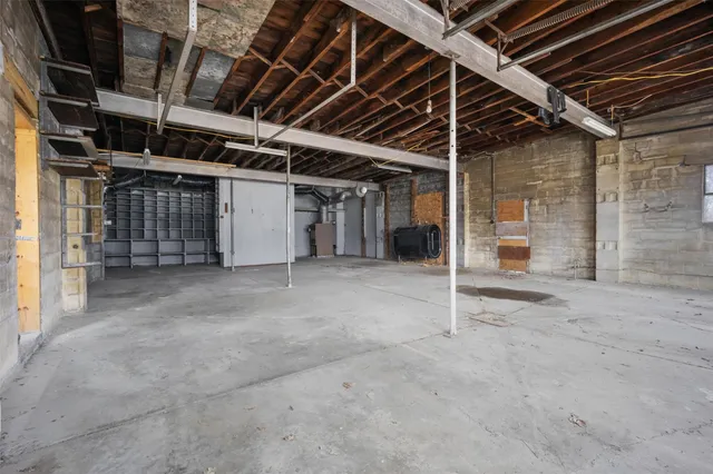 a view of a house with a yard and large tree