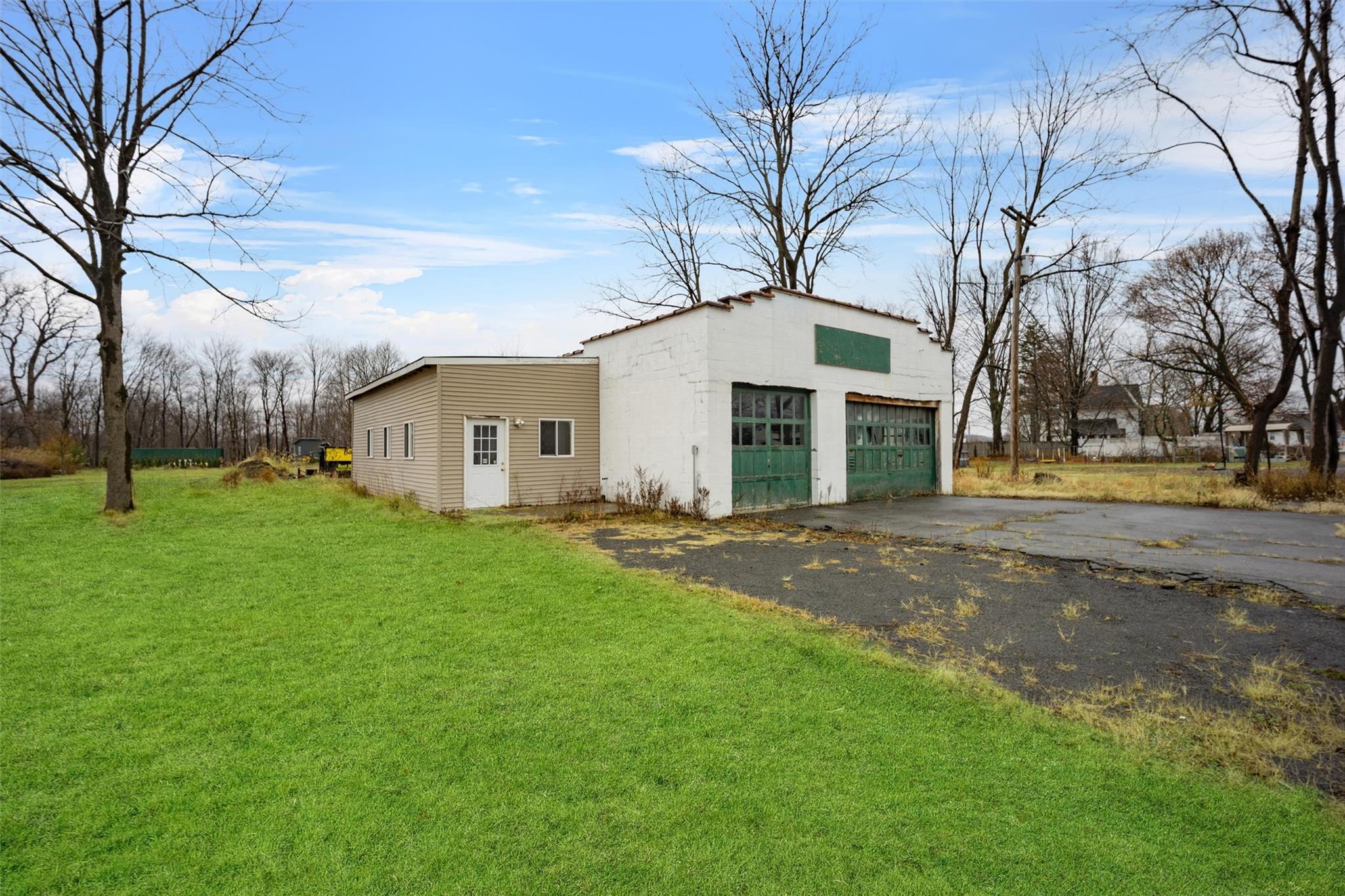 79 Maple Avenue Catskill, NY 12414 - Photo 4 of 35 View of outdoor structure featuring a garage and a lawn