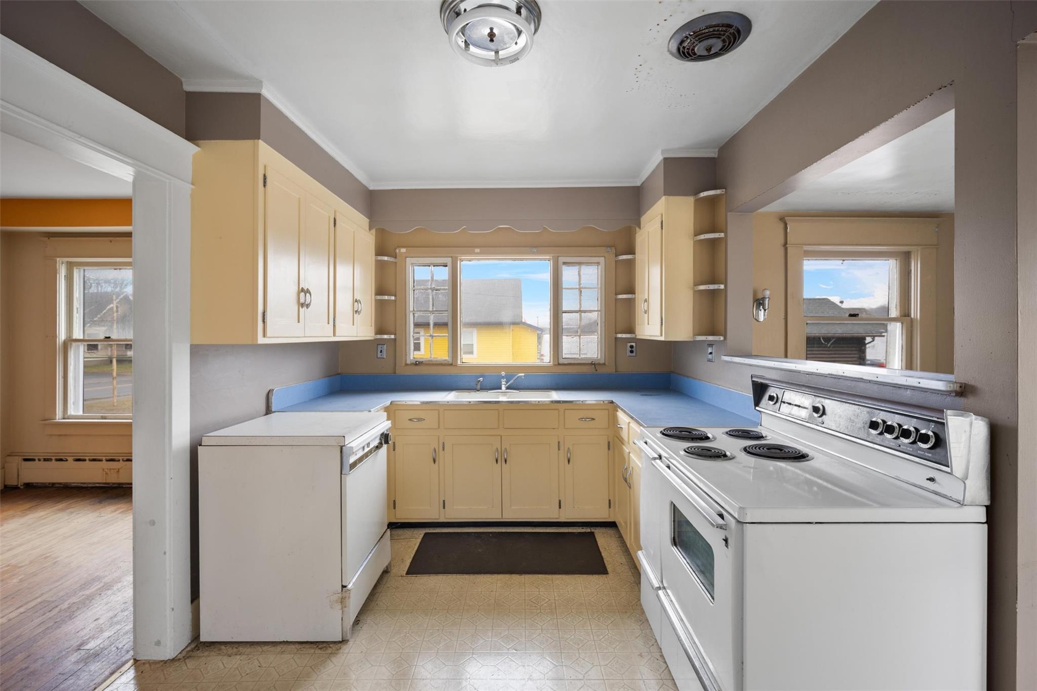 79 Maple Avenue Catskill, NY 12414 - Photo 7 of 35 Kitchen featuring white appliances, a wealth of natural light, a baseboard radiator, and sink