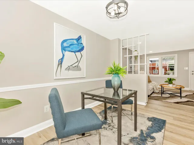 a view of a dining room with furniture and a potted plant