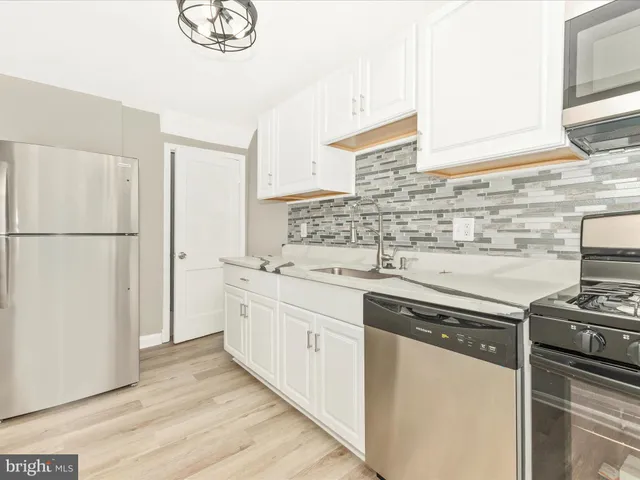 a kitchen with a sink stove and refrigerator