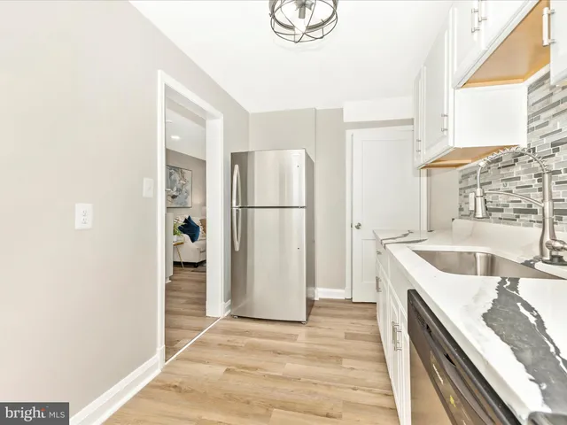 a kitchen with a refrigerator and a sink