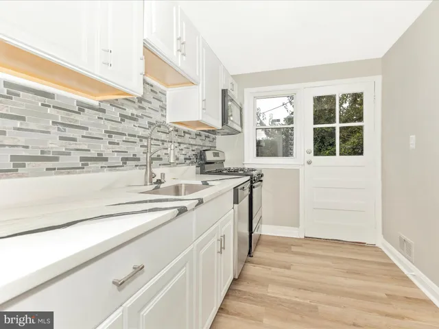 a kitchen with a sink and a window