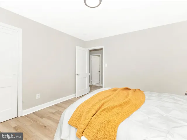 a bedroom with a bed and tub