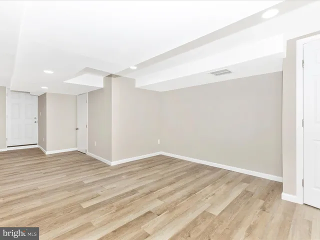 a view of hallway with wooden floor