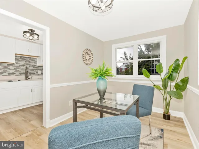 a living room with furniture potted plant and window