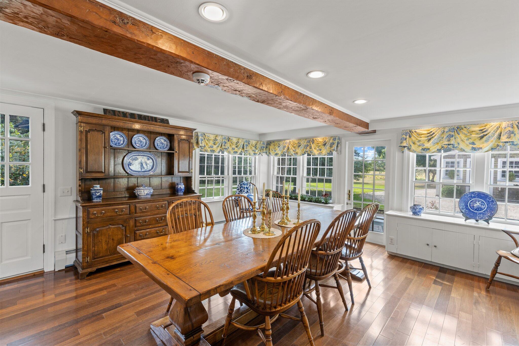 4259 Main Street Barnstable, MA 02630 - Photo 27 of 69 a view of a dining room with furniture large windows and wooden floor