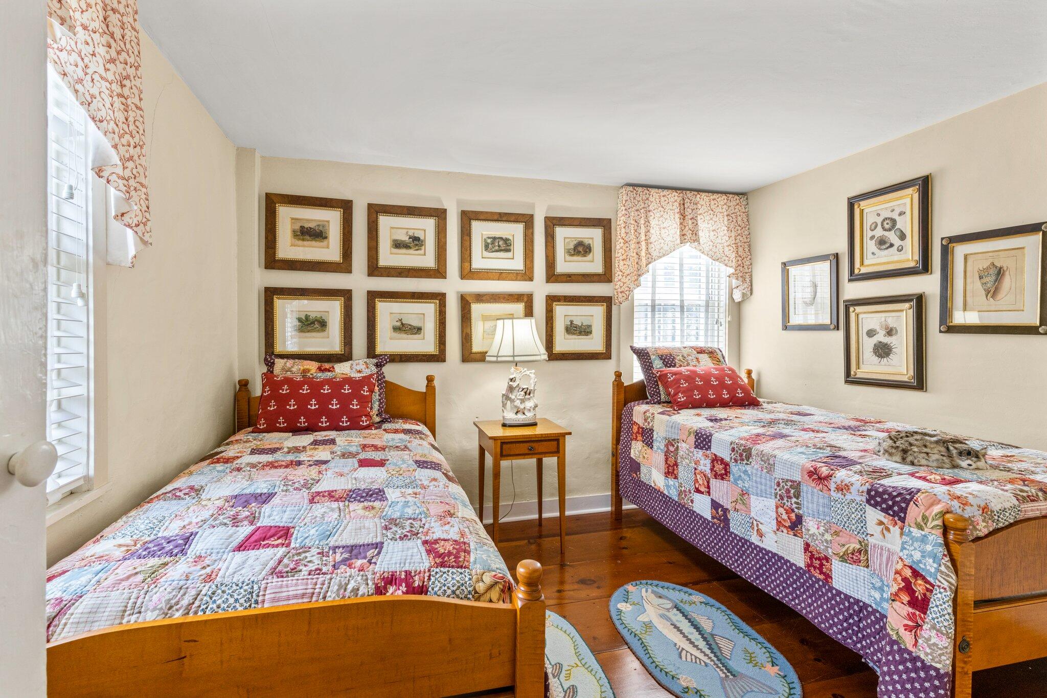 4259 Main Street Barnstable, MA 02630 - Photo 32 of 69 a bedroom with two beds and a lamp on dresser